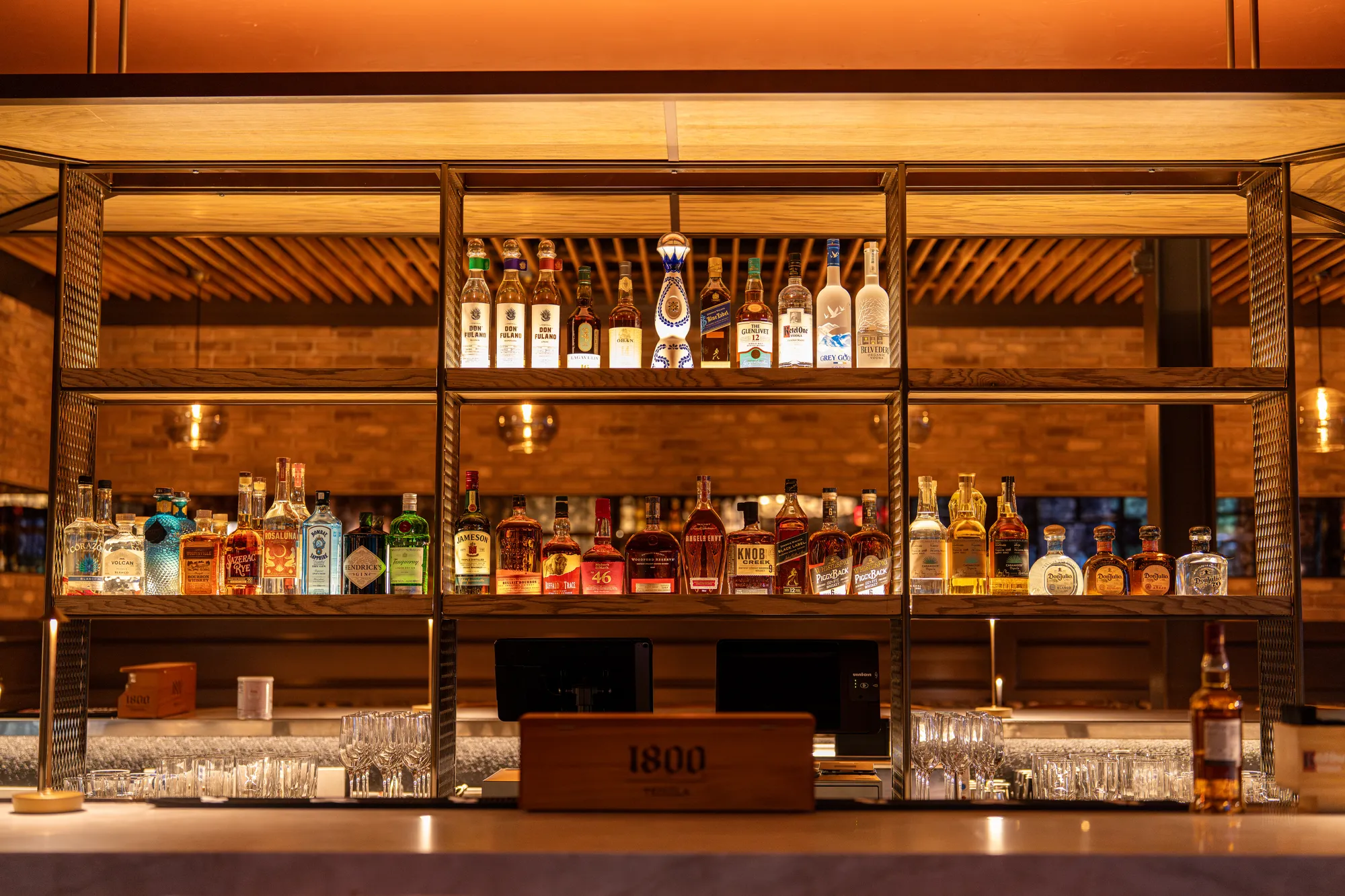 Back-lit bar shelf lined with spirits